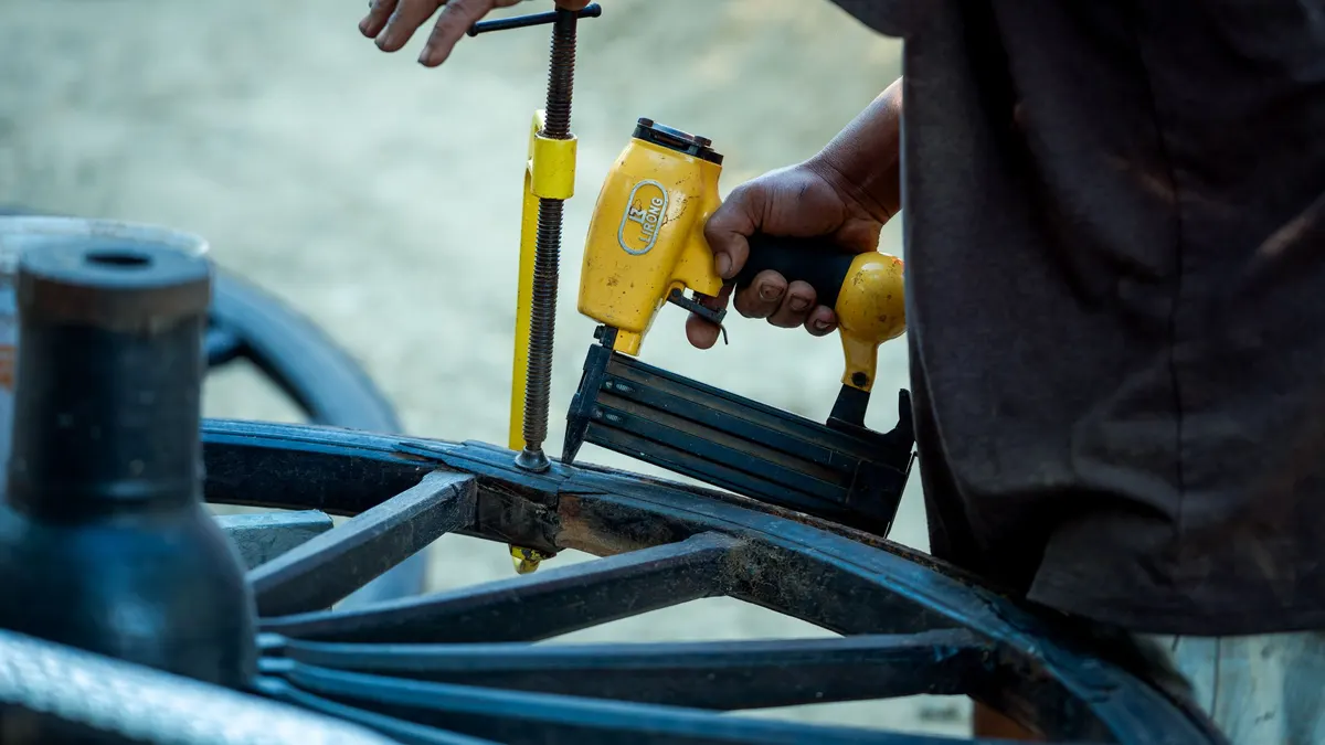 Person using a pneumatic nail gun