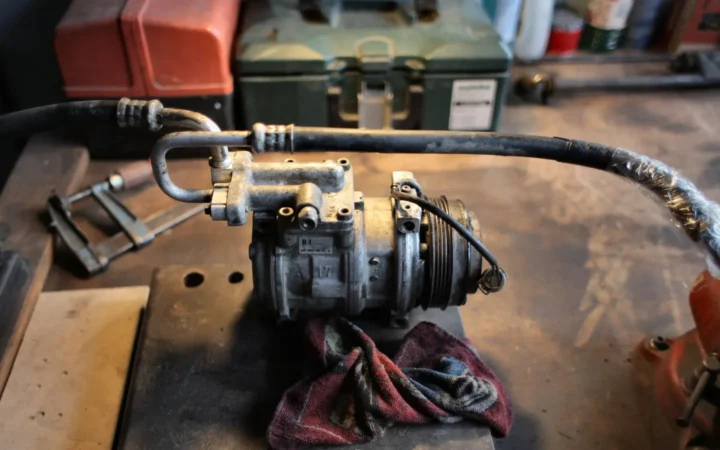 Small air compressor on a worn workbench