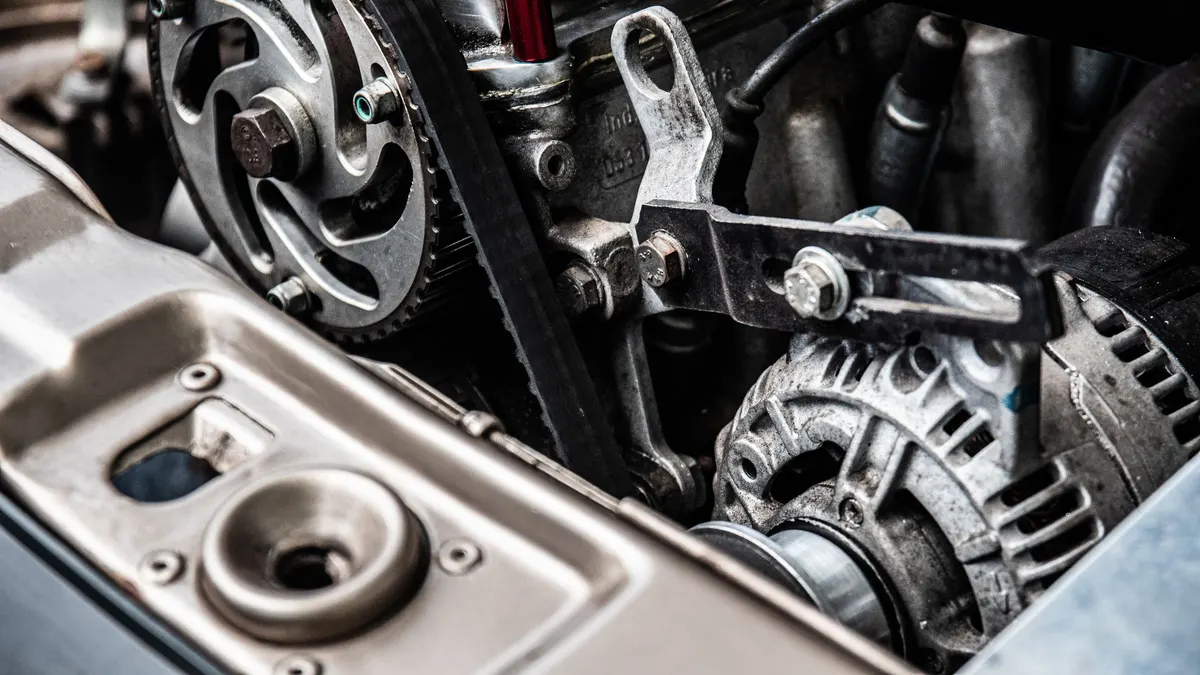 Close-up of an engine belt running over pulleys