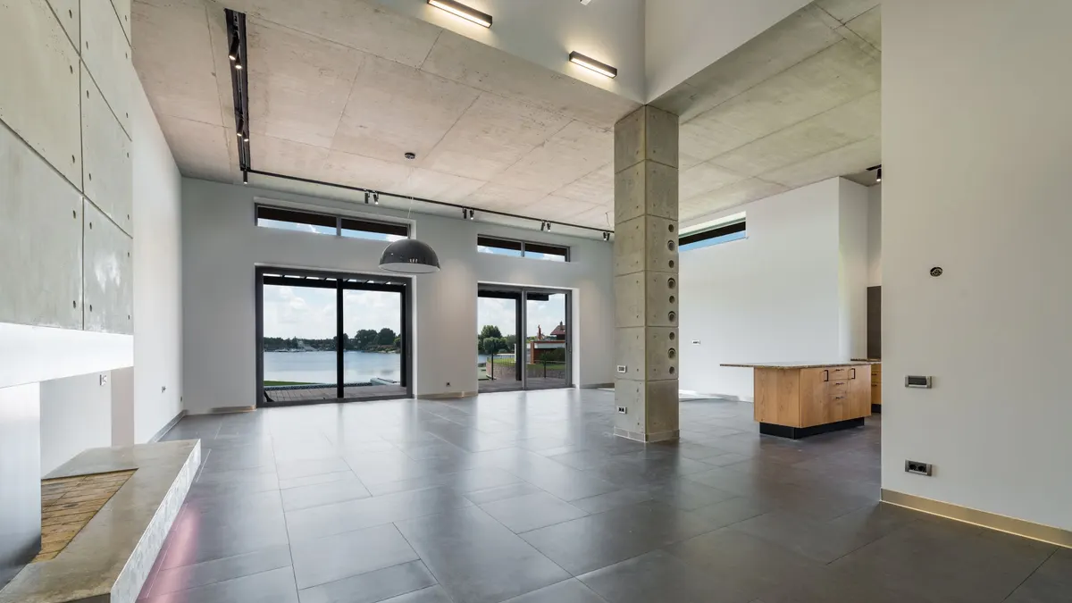 Large open room with a bare gray concrete floor