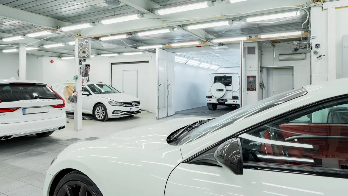 Bright white garage with cars parked on a clean coated floor