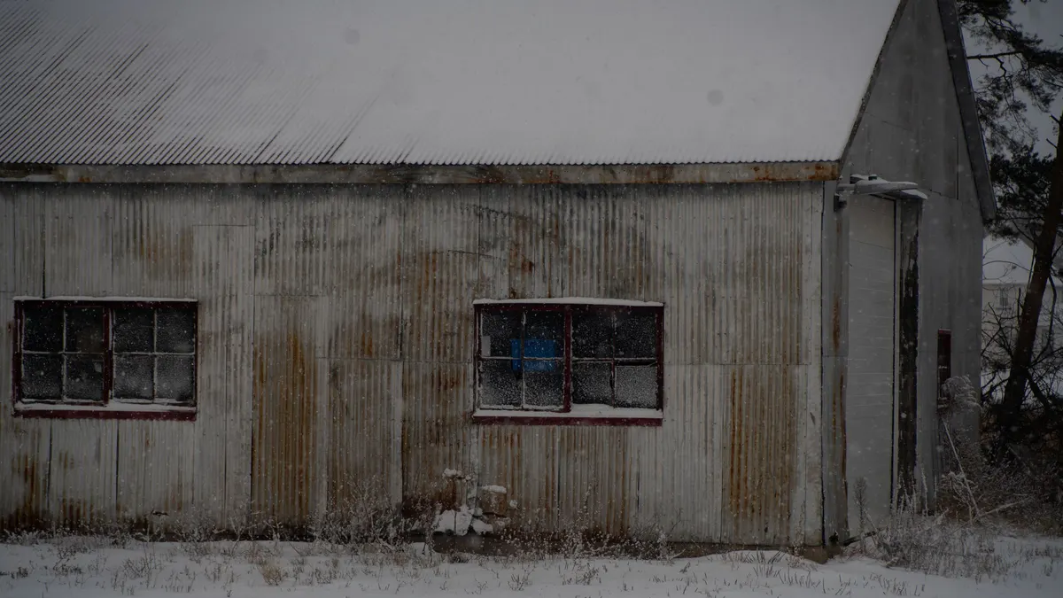 Weathered shed with windows on a gray winter day