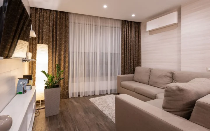 Living room with a wall-mounted mini split unit near the ceiling