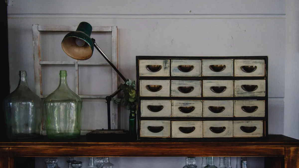 Small drawer cabinet and glass jars on a workbench