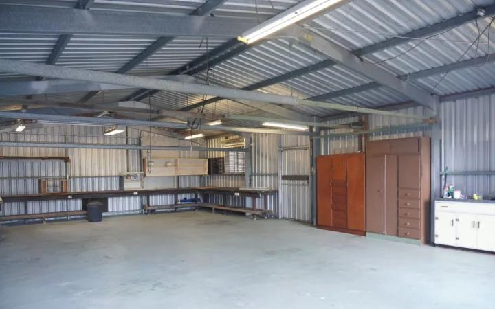 Clean garage interior with cabinets along the back wall
