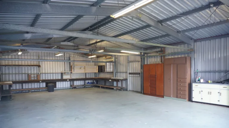 Clean garage interior with cabinets along the back wall