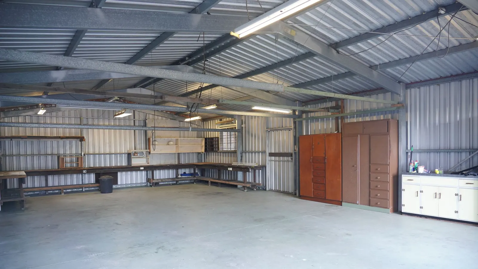 Clean garage interior with cabinets along the back wall