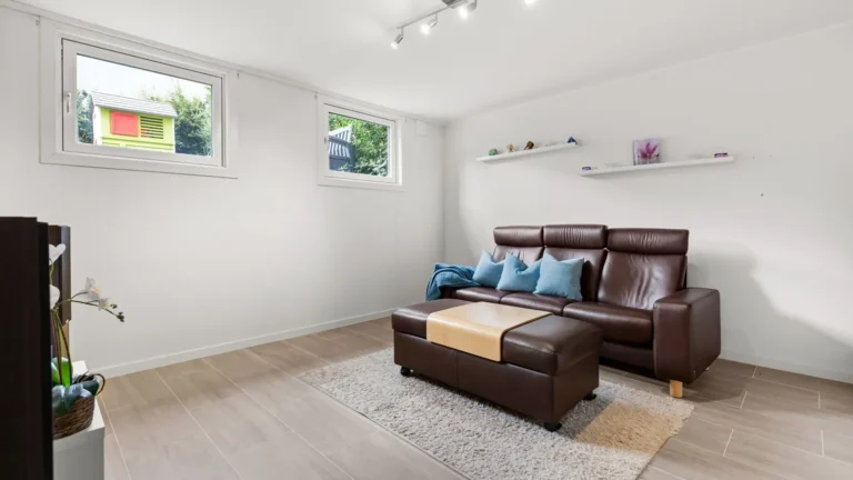 Bright living room with a leather sofa and a window