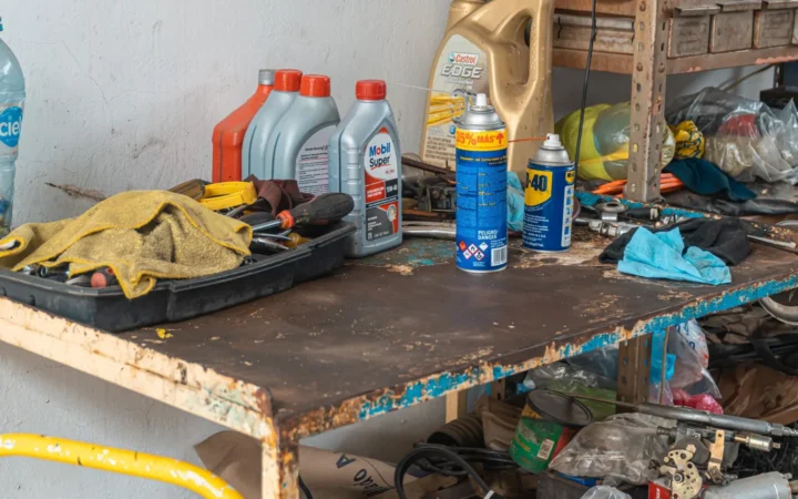 Workbench with oil bottles, spray lubricant cans and work gloves