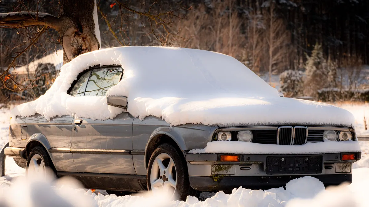Car covered in snow on a winter day