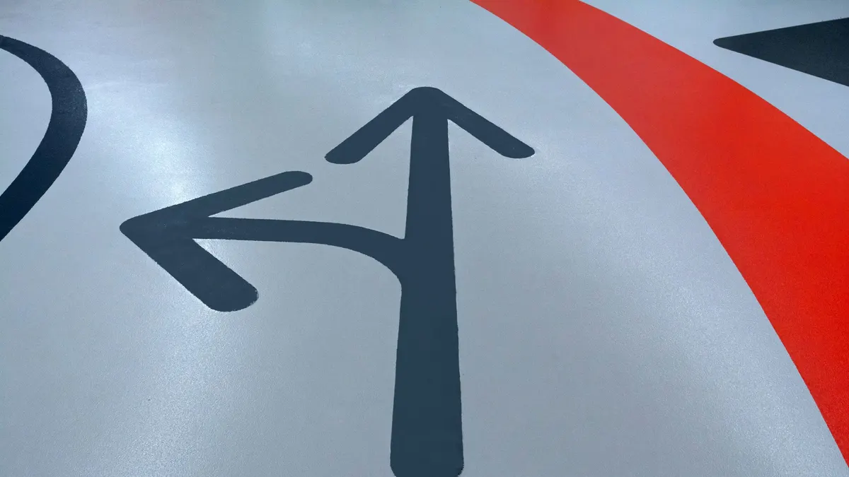 Painted arrows on a smooth gray floor
