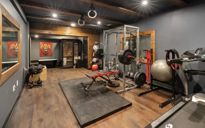 Home gym with a squat rack, bench and rubber flooring