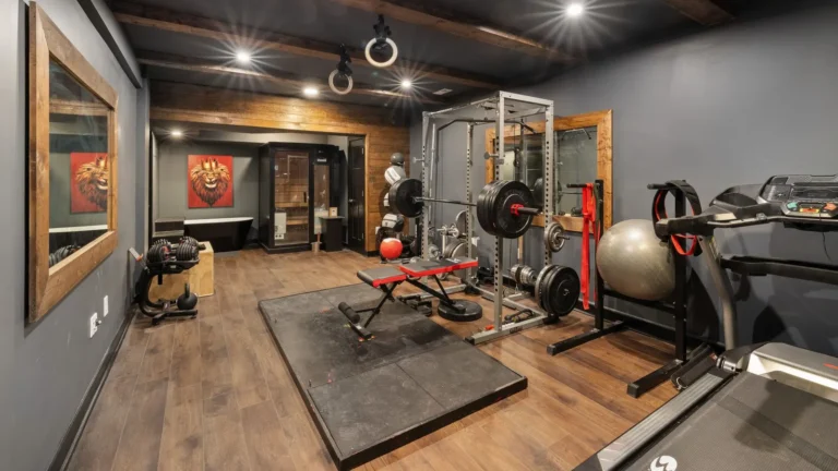 Home gym with a squat rack, bench and rubber flooring
