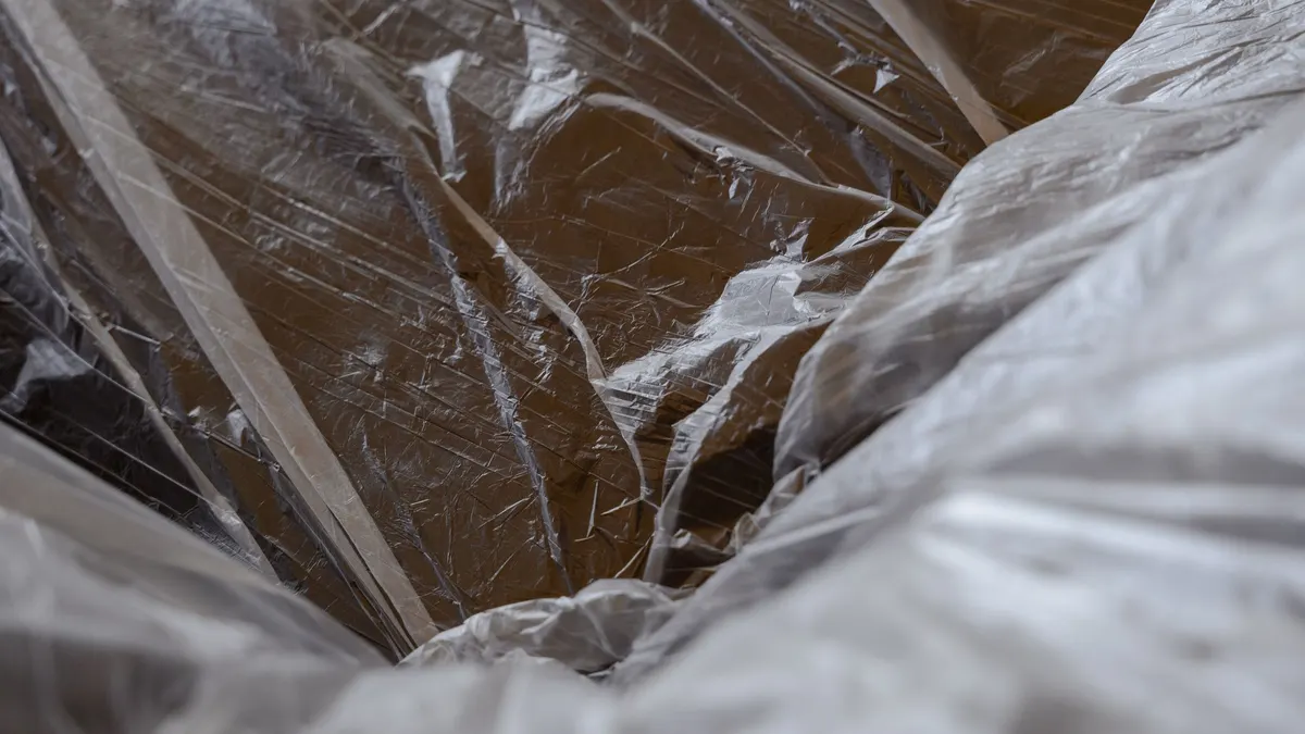 Clear plastic sheeting draped over a building surface