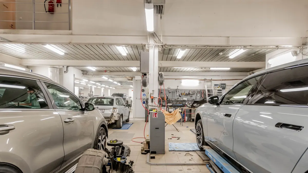 Workshop with cars under bright overhead lighting