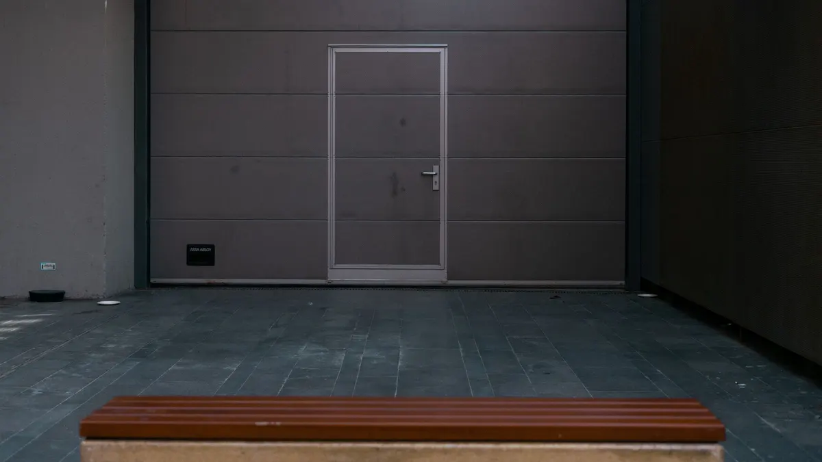 Closed gray garage door with a small walk-through door