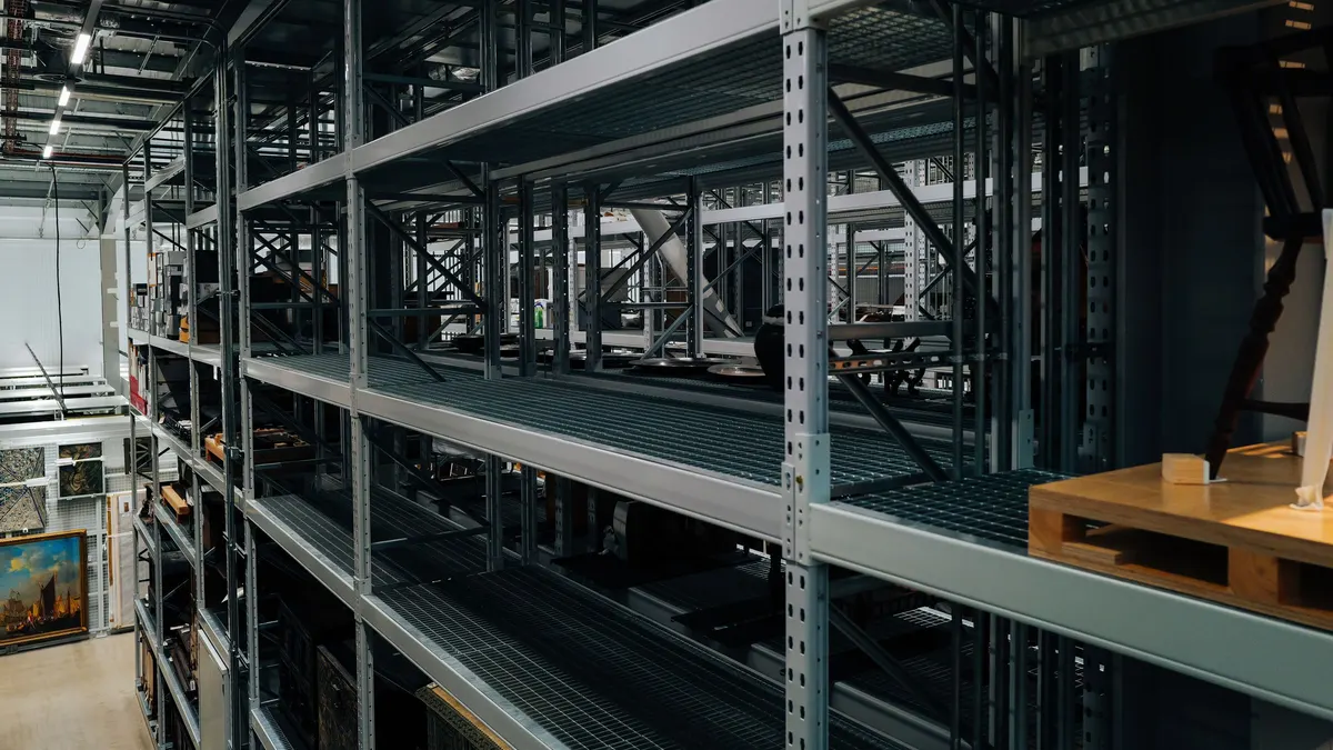 Tall empty metal shelving units in a storage room