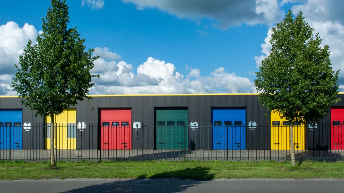 Row of colorful garage doors on a sunny day