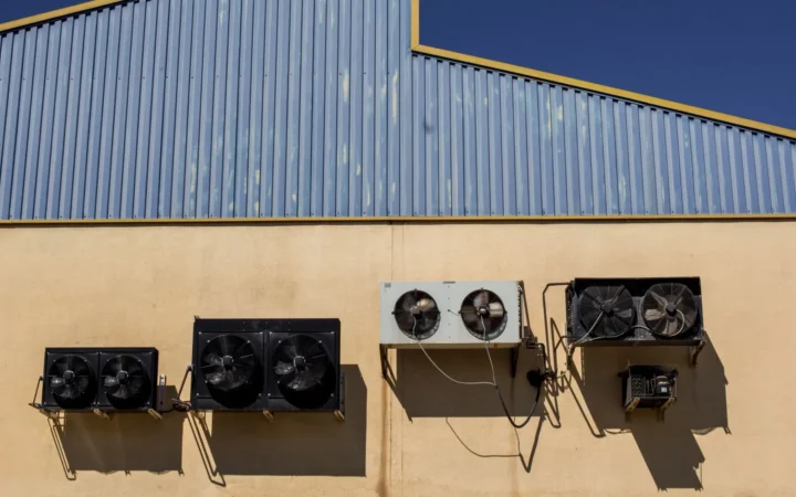 Exhaust fans mounted high on the wall of a building