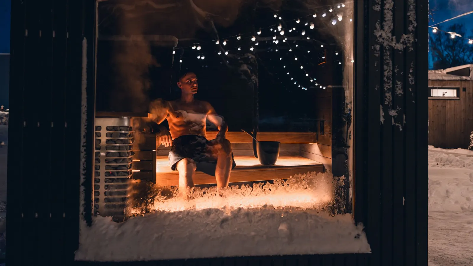 Wooden garage door in a brick wall with snow on the ground in winter