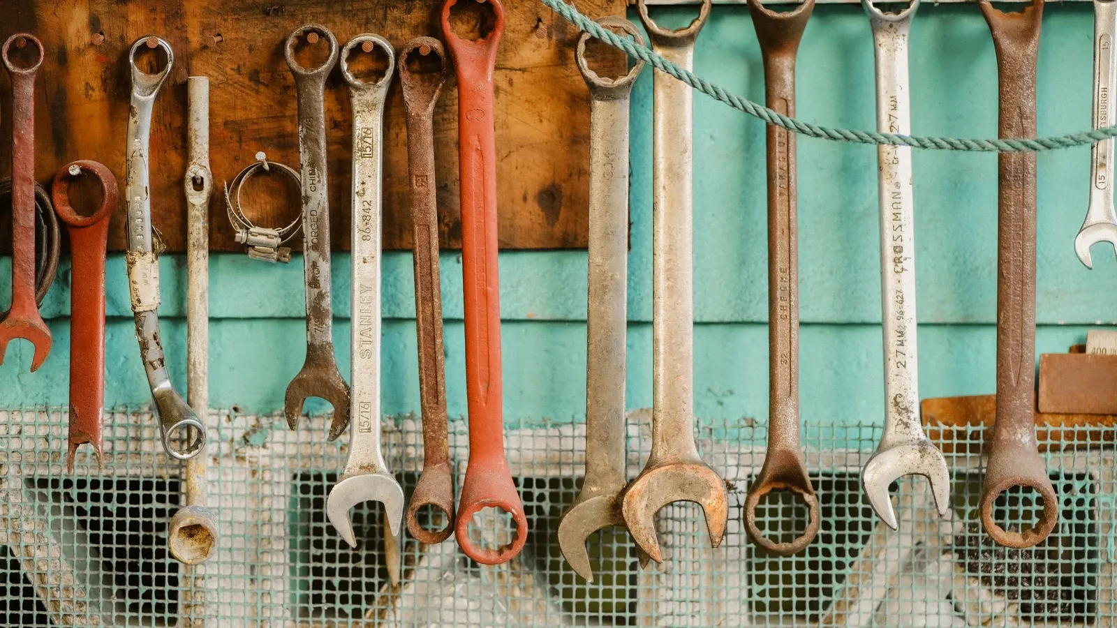 Row of wrenches hanging in order on a workshop wall