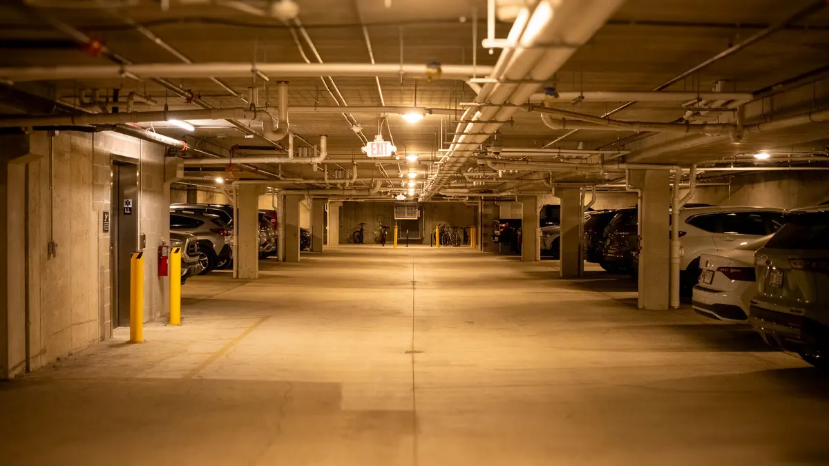 Garage ceiling with lights and parked cars below