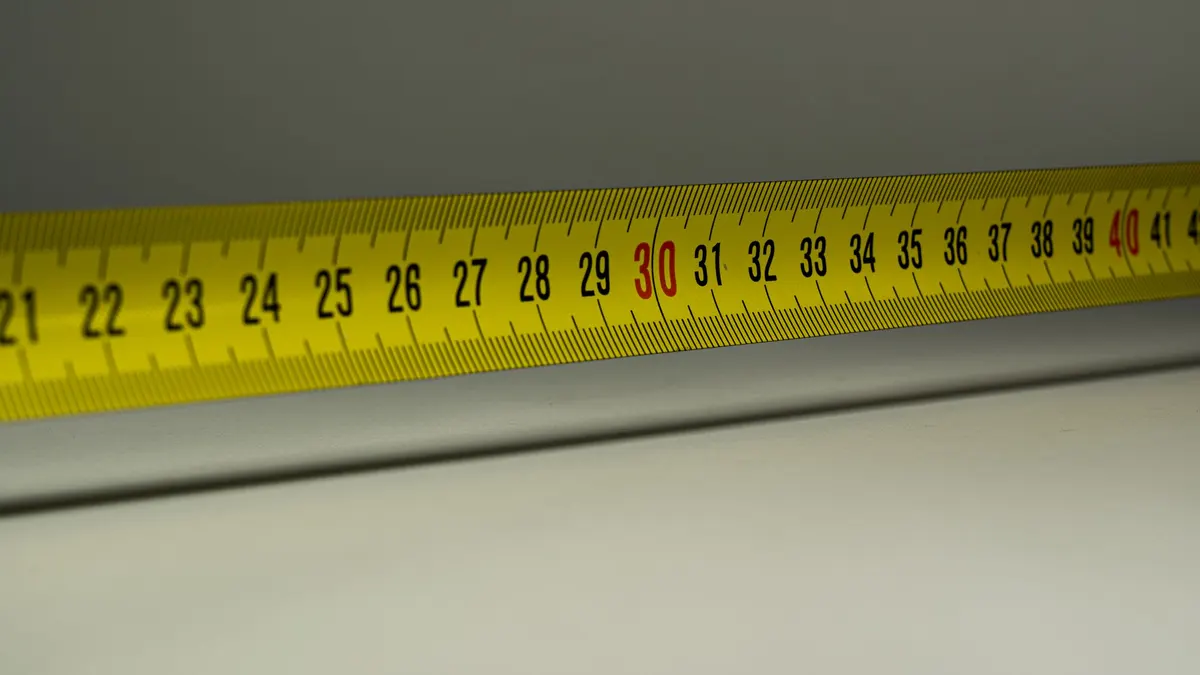 Yellow tape measure extended across a surface